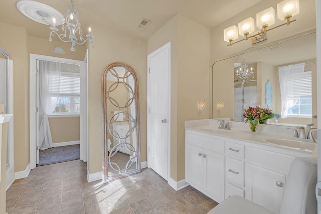 bathroom featuring an inviting chandelier and vanity