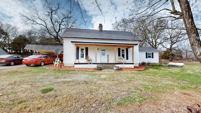 bungalow-style house featuring covered porch and a front yard