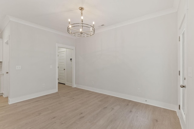 empty room featuring crown molding, an inviting chandelier, and light wood-type flooring