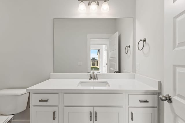 bathroom featuring vanity and toilet