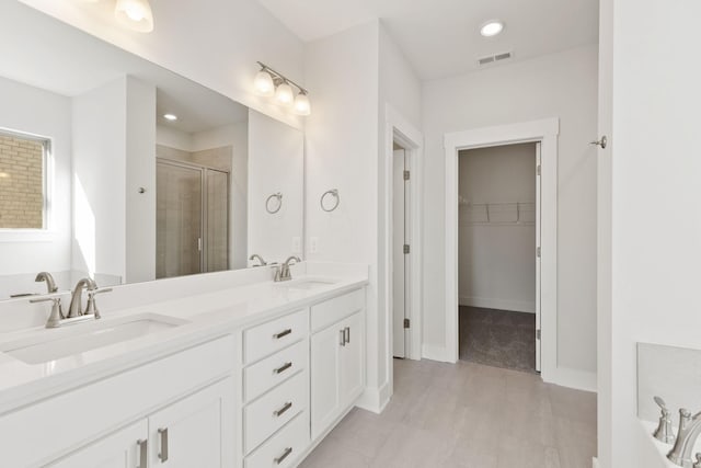 bathroom with vanity and shower with separate bathtub