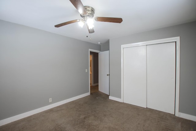 unfurnished bedroom with ceiling fan, a closet, carpet flooring, and baseboards