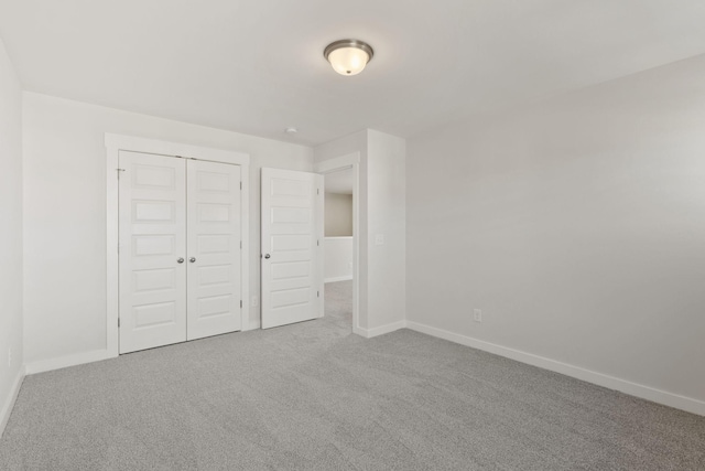 unfurnished bedroom featuring a closet and carpet