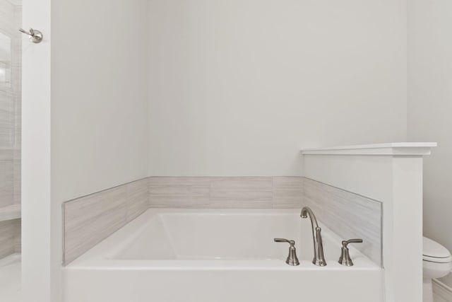 bathroom with a bathing tub and toilet