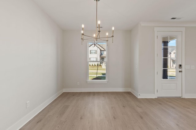 unfurnished dining area featuring a notable chandelier and light wood-type flooring