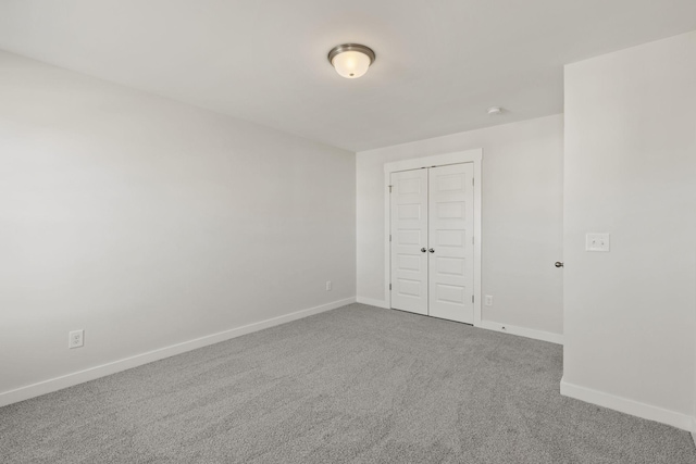 unfurnished bedroom featuring carpet flooring and a closet