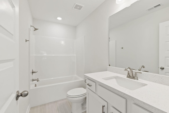 full bathroom featuring vanity, bathtub / shower combination, and toilet