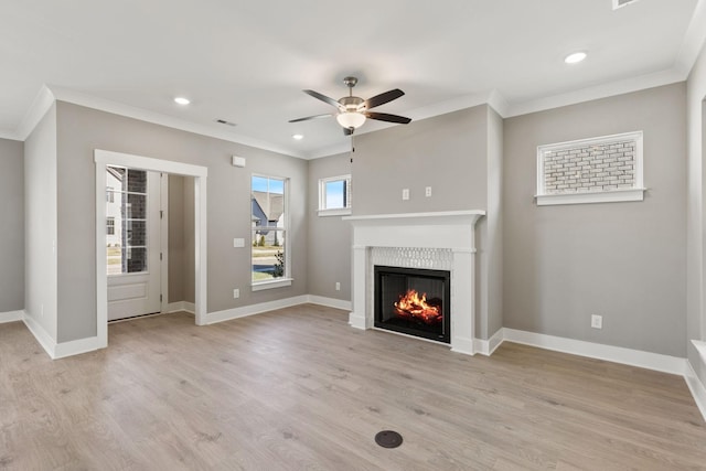 unfurnished living room with light hardwood / wood-style flooring, ornamental molding, and ceiling fan