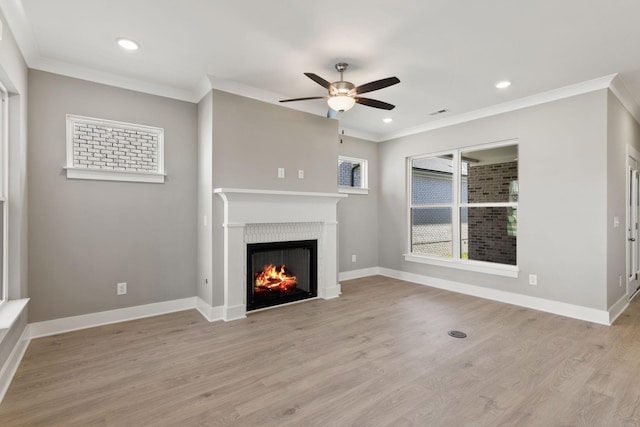 unfurnished living room with ornamental molding, light hardwood / wood-style floors, and ceiling fan