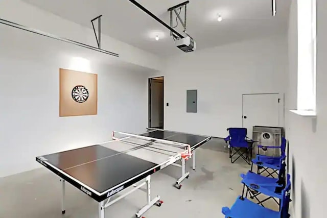 playroom with concrete flooring and electric panel