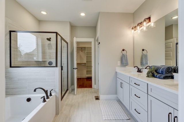 bathroom with vanity and separate shower and tub