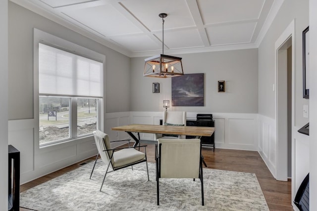 dining area featuring an inviting chandelier, wood-type flooring, and coffered ceiling