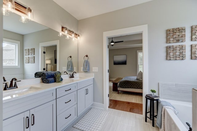 bathroom featuring vanity, a bathtub, and plenty of natural light