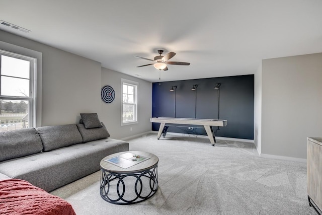 living room with light carpet and ceiling fan