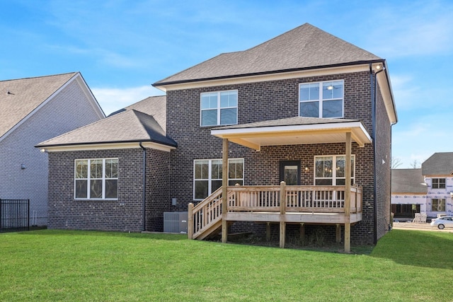 rear view of house featuring a wooden deck, a yard, and central AC unit