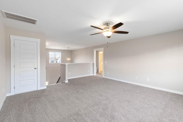 spare room with ceiling fan and carpet flooring