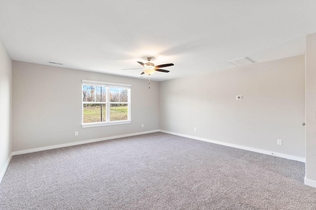 unfurnished room with ceiling fan and carpet