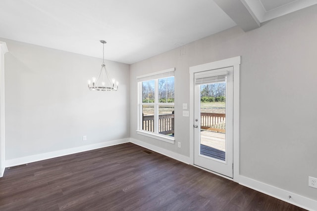 unfurnished dining area featuring dark wood-type flooring and a notable chandelier