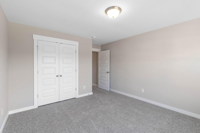 unfurnished bedroom featuring a closet and carpet flooring