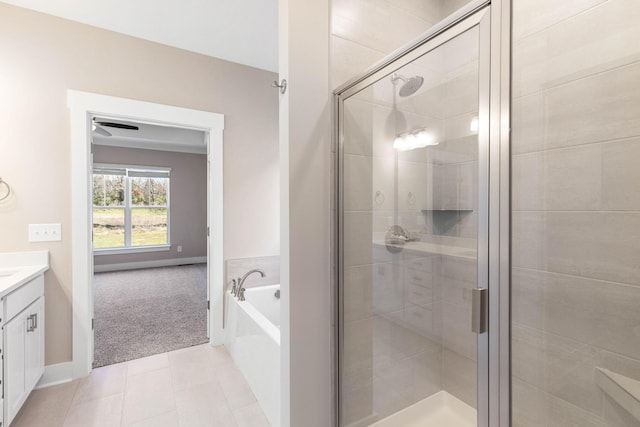 bathroom with vanity, tile patterned floors, and plus walk in shower