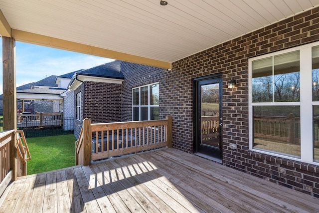 wooden terrace with a lawn