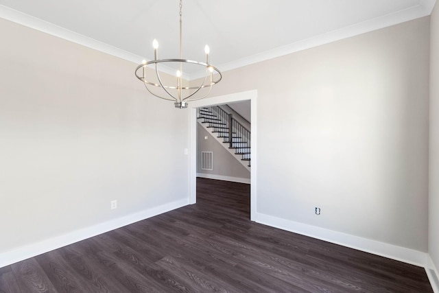 unfurnished dining area with dark wood-type flooring, ornamental molding, and a notable chandelier