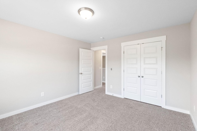 unfurnished bedroom featuring carpet floors and a closet