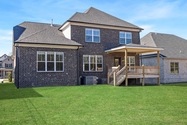 rear view of house with cooling unit, a yard, and a deck