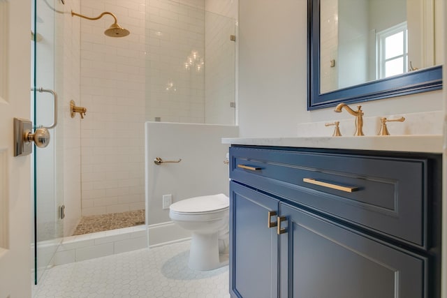 bathroom featuring vanity, a shower with door, tile patterned floors, and toilet