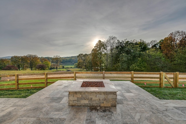 view of patio / terrace featuring a fire pit and a rural view