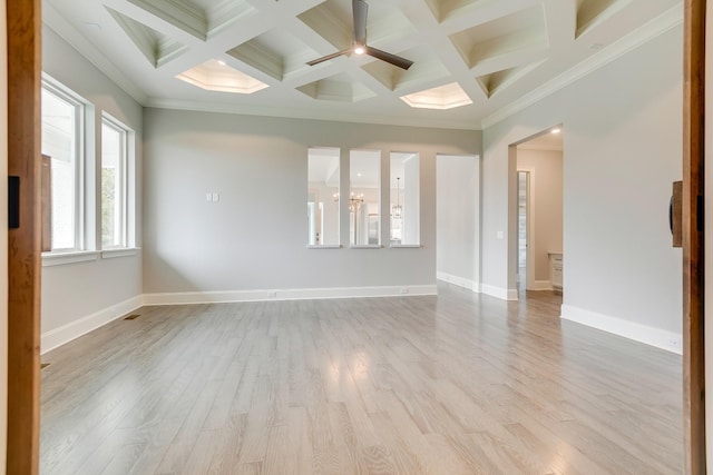 unfurnished room featuring beamed ceiling, ornamental molding, and light wood-type flooring