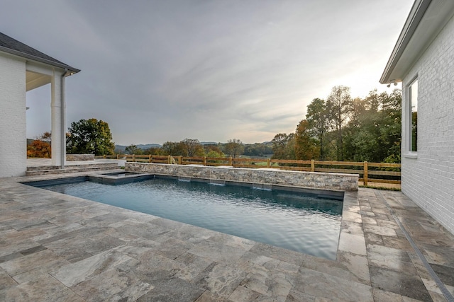 view of pool with an in ground hot tub and a patio area