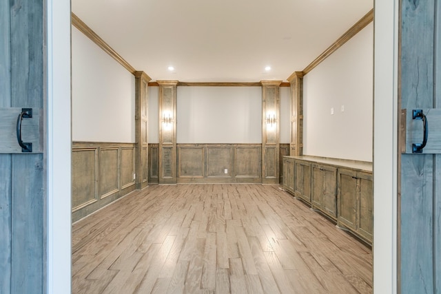 unfurnished room featuring crown molding and light wood-type flooring