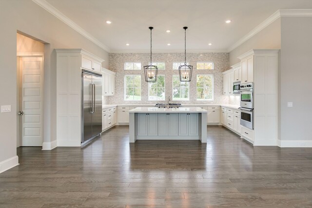 kitchen with white cabinetry, a center island with sink, and appliances with stainless steel finishes