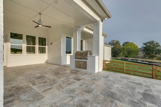 view of patio / terrace with ceiling fan, an outdoor kitchen, and grilling area