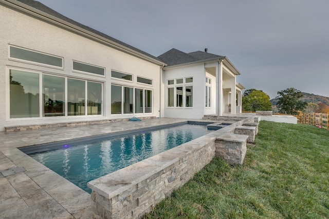 view of swimming pool with a lawn, a hot tub, and a patio area