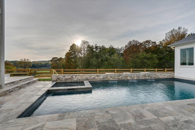 view of pool with a patio and an outdoor hot tub