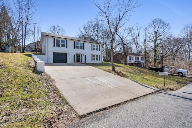 view of front of house featuring a garage and a front lawn