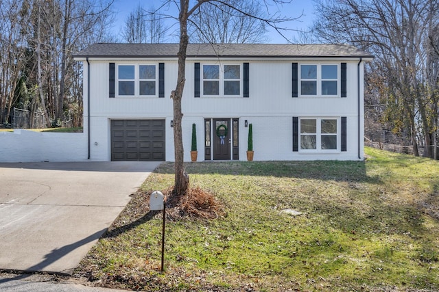 view of front of house with a garage and a front lawn