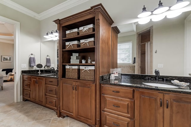 bathroom with tile patterned flooring, crown molding, vanity, and walk in shower