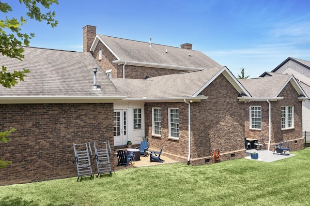 rear view of house with a patio area and a lawn