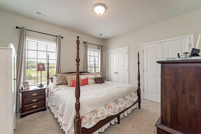 carpeted bedroom with multiple closets