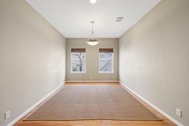 spare room with wood-type flooring