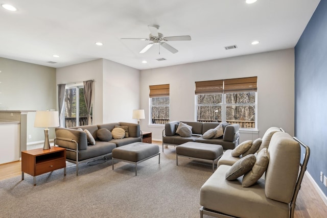 living room featuring ceiling fan and light hardwood / wood-style flooring