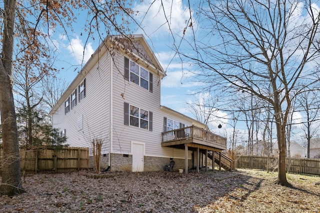 rear view of property featuring a wooden deck