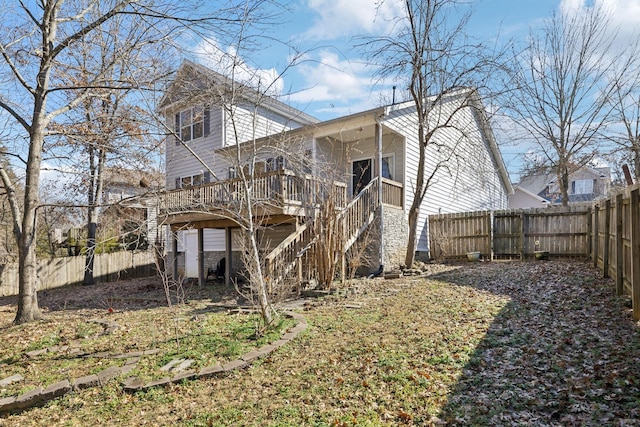 rear view of house featuring a wooden deck