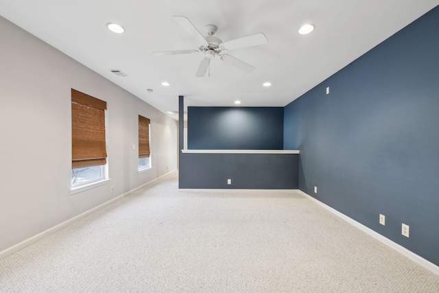 carpeted empty room featuring ceiling fan