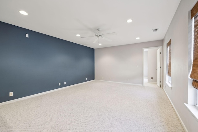 unfurnished room featuring light carpet and ceiling fan