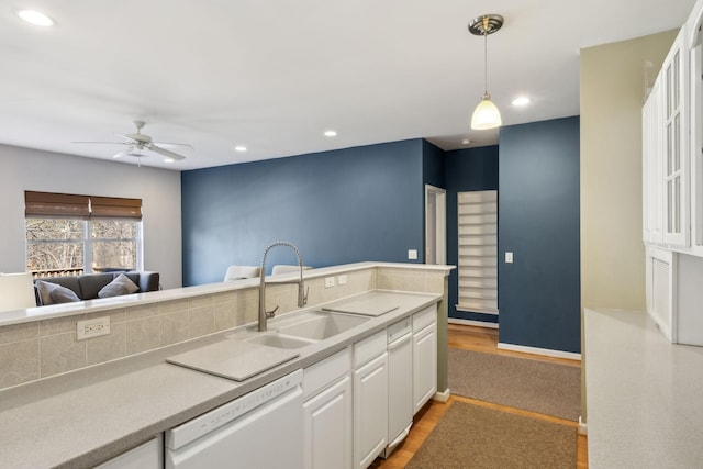 kitchen with sink, ceiling fan, hanging light fixtures, white dishwasher, and white cabinets