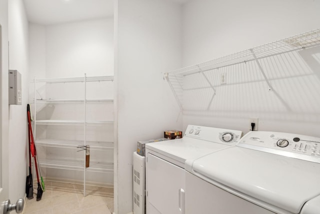 laundry room featuring separate washer and dryer and light tile patterned floors